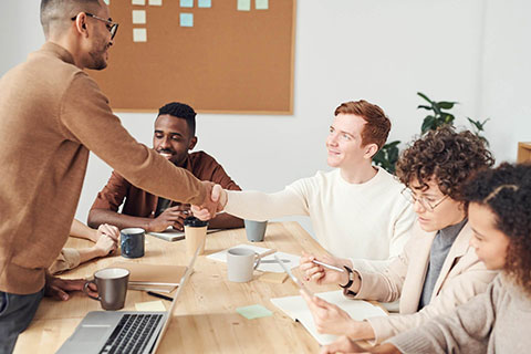 Colleagues shaking hands during a positive meeting.