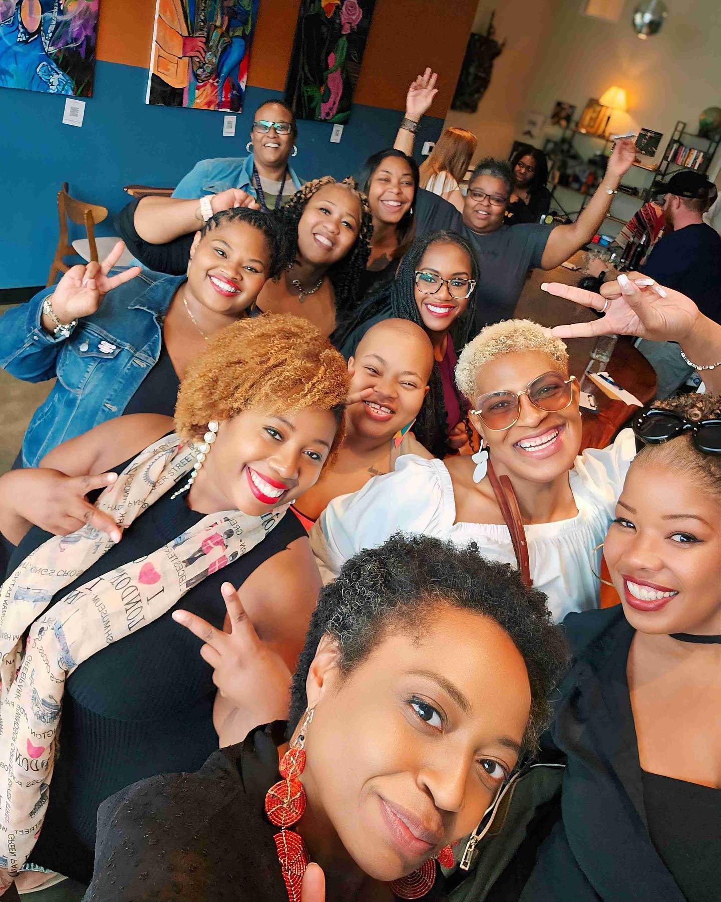 A joyful group selfie at a lively social gathering.